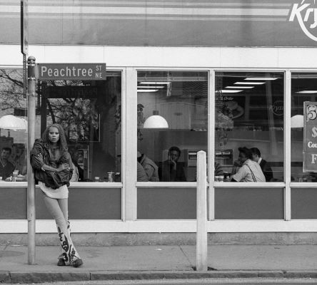 A young RuPaul leans against a Peachtree Street sign outside of a Krystal restaurant in Atlanta in 1988.